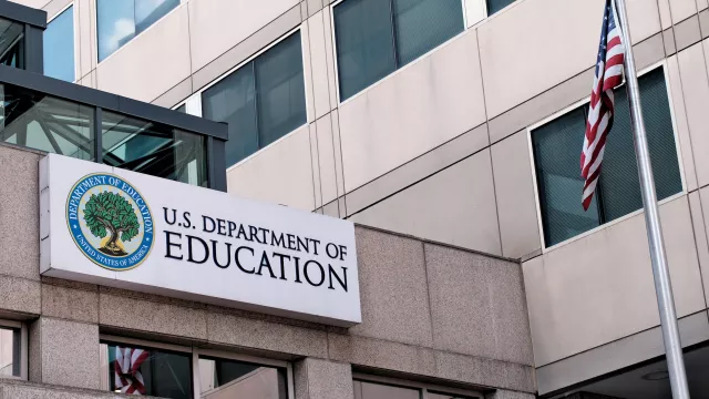 Exterior sign and US flag in front of the Department of Education offices in Washington